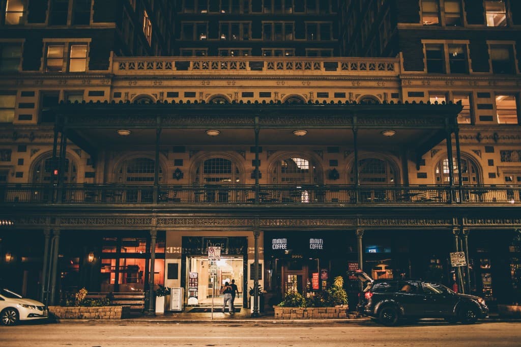 A small-business storefront lit up at night